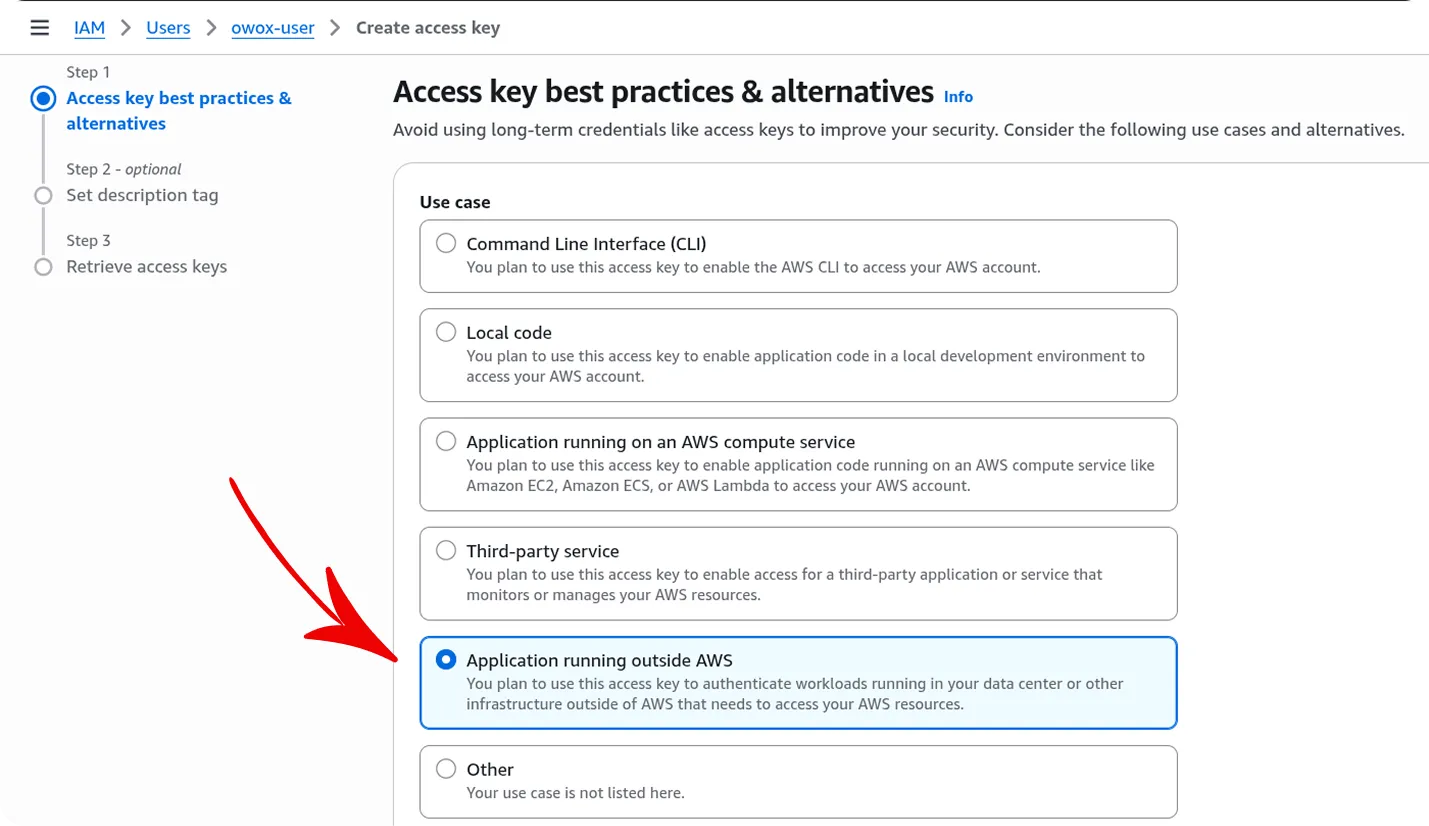 AWS Create Access Key dialog showing Step 1: Access key best practices and alternatives. The page explains to avoid long-term credentials and presents use case options including Command Line Interface, Local code, Application running on AWS compute service, Third-party service, and Application running outside AWS, which is selected with a blue highlight and red arrow. The interface has a professional layout with step navigation on the left side and informational content on the right.
