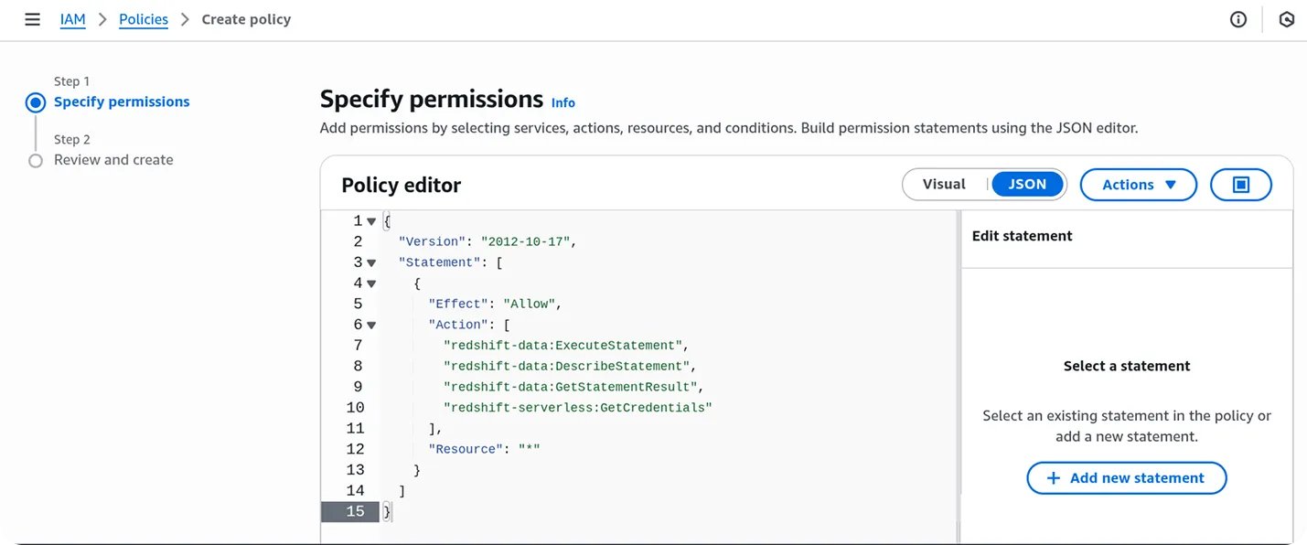 AWS IAM policy creation interface showing Step 1: Specify permissions with a policy editor displaying JSON policy syntax. The policy editor shows Version 2012-10-17 and a Statement array with Allow Effect and Action array containing redshift-data permissions: ExecuteStatement, DescribeStatement, GetStatementResult, and redshift-serverless. The Resource field is set to asterisk. The top navigation shows IAM > Policies > Create policy breadcrumb. Step 2 Review and create is visible in the left sidebar. The interface has a professional AWS management console layout with Visual and JSON tabs, and Actions dropdown buttons in the top right corner.